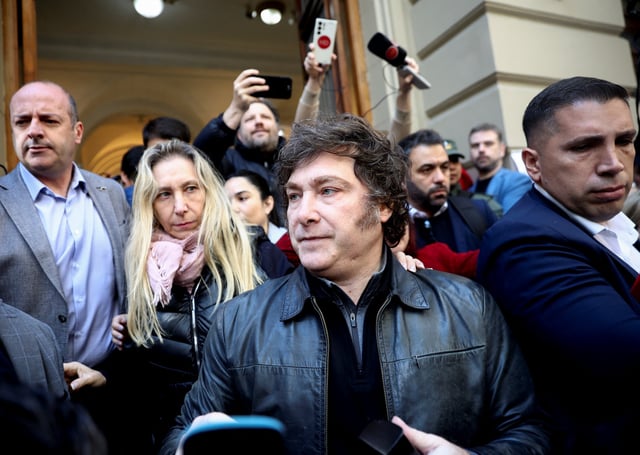 Argentina's President Javier Milei speaks to the media as General Secretary of the Presidency and sister of the president, Karina Milei looks on on the day they vote in the legislative elections of the city of Buenos Aires, Argentina, May 18, 2025. REUTERS/Tomas Cuesta