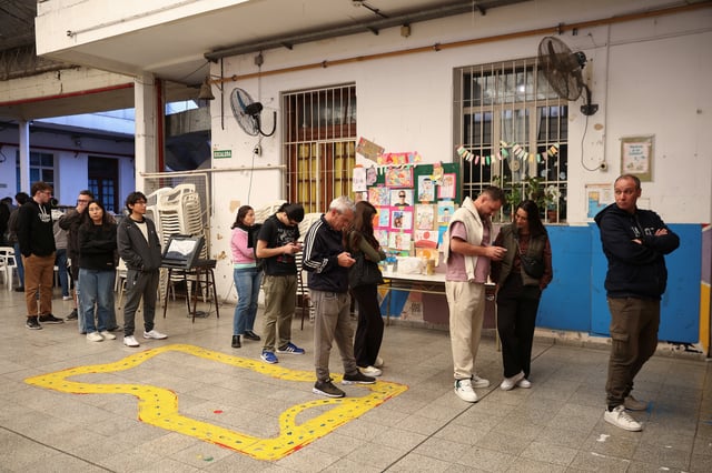 People stand in line at a polling station, during the legislative elections of the city of Buenos Aires, Argentina, May 18, 2025. REUTERS/Tomas Cuesta