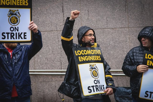 Members of the Brotherhood of Locomotive Engineers and Trainmen BLET Union Hold posters as they take part during a Strike outside NJ Transit's Headquarters on May 16, 2025 in Newark, New Jersey.