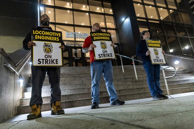 Union members from the Brotherhood of Locomotive Engineers and Trainmen form a picket line outside the NJ Transit Headquarters on Friday, May 16, 2025 in Newark, New Jersey. (AP Photo/Stefan Jeremiah)