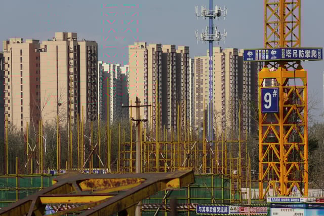 Residential buildings  are pictured near a construction site in Beijing, China April 14, 2022. Picture taken April 14, 2022. REUTERS/Tingshu Wang/ File Photo