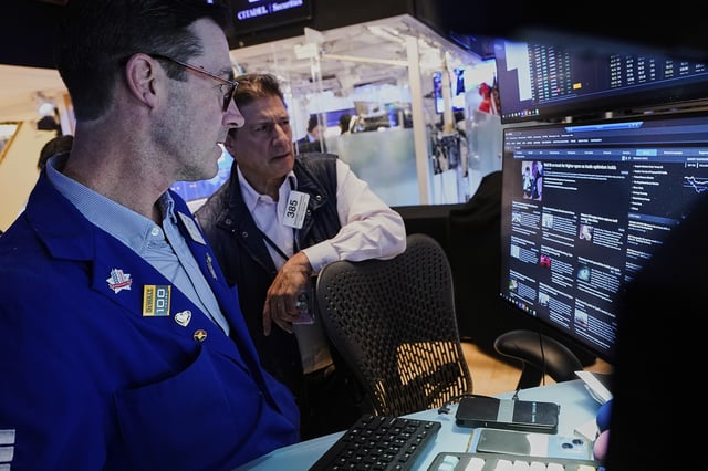 Specialist John McNierney, left, and trader Anthony Carannante work on the floor of the New York Stock Exchange, Wednesday, May 14, 2025. (AP Photo/Richard Drew)