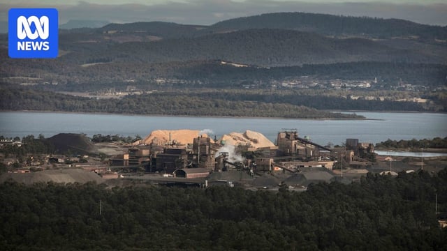 Aerial view of a smelter facility near a waterway.