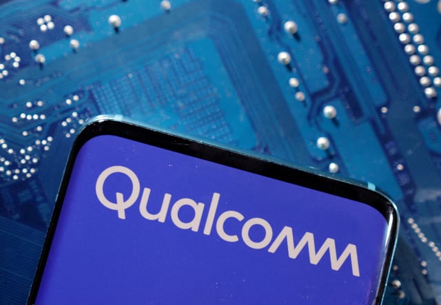 A smartphone with a displayed Qualcomm logo is placed on a computer motherboard in this illustration taken March 6, 2023. REUTERS/Dado Ruvic/Illustration/File Photo