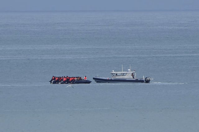 FILE - A boat thought to carry migrants is escorted by a vessel from the French Gendarmerie Nationale in the English Channel off Wimereux beach, France, Wednesday, Sept. 4, 2024. (AP Photo/Nicolas Garriga, File)