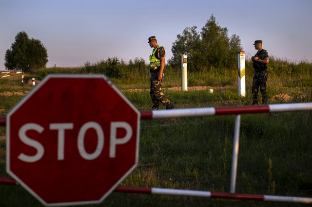 FILE - In this file photo taken on Friday, July 9, 2021, members of the Lithuania State Border Guard Service patrol on the border with Belarus, near the village of Purvenai, Lithuania. (AP Photo/Mindaugas Kulbis, File)