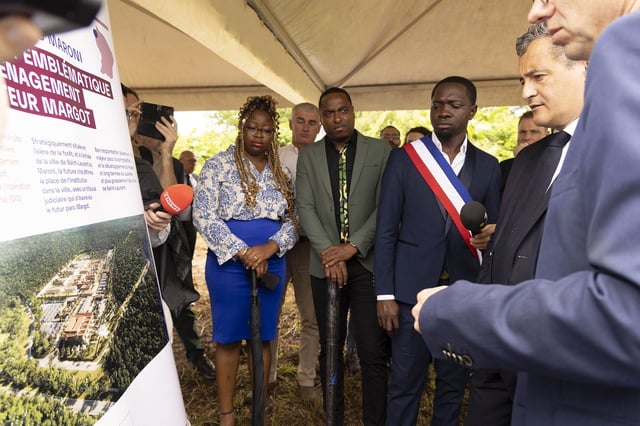 Darmanin (right) examines plans for the new prison during his visit to French Guiana.