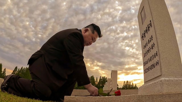Kim Jong-un laying a flower at the grave of Hyon Chol-hae
