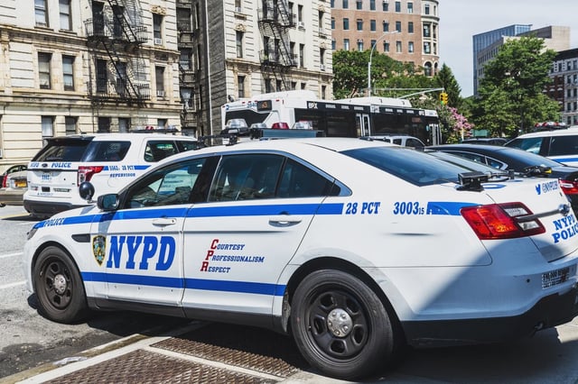 An NYPD vehicle is parked in Harlem in 2018.