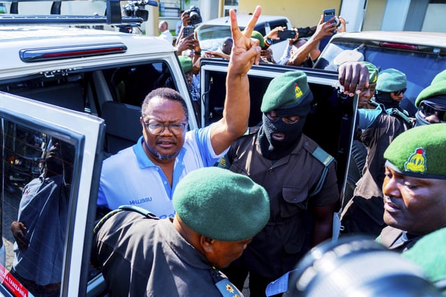 Tanzania's main opposition leader Tundu Lissuat, centre, gestures as he arrive at Kisutu magistrate's court in Dar es Salaam, Tanzania Monday, May 19, 2025. (AP Photo/Derick Katunzi)