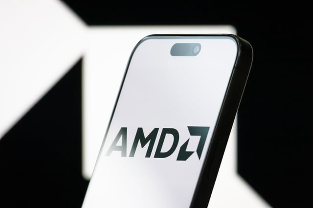 CHONGQING, CHINA - MAY 04: In this photo illustration, the logo of Advanced Micro Devices, Inc. (AMD) is displayed on a smartphone screen, with the company's branding visible in the background, on May 04, 2025, in Chongqing, China. AMD is an American multinational semiconductor company headquartered in Santa Clara, California, known for developing computer processors, graphics cards, and related technologies for business and consumer markets. (Photo illustration by Cheng Xin/Getty Images)
