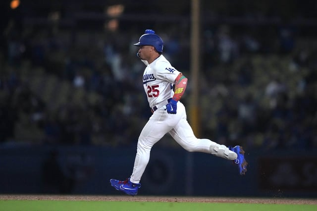Sep 13, 2023; Los Angeles, California, USA; Los Angeles Dodgers second baseman Kolten Wong (25) runs the bases after hitting a home run in the ninth inning against the San Diego Padres at Dodger Stadium. Mandatory Credit: Kirby Lee-USA TODAY Sports