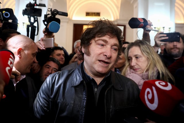 Argentina's President Javier Milei speaks to the media as General Secretary of the Presidency and sister of the president, Karina Milei looks on on the day they vote in the legislative elections of the city of Buenos Aires, Argentina, May 18, 2025. REUTERS/Tomas Cuesta