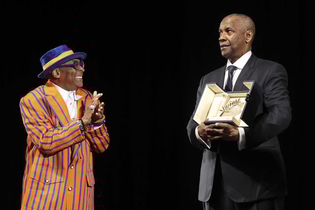Director Spike Lee applauds Denzel Washington after the actor received the honorary Palme d’Or (Golden Palm) ahead of the world premiere of “Highest 2 Lowest” at the 78th edition of the Cannes Film Festival in Cannes, France, Monday, May 19, 2025.
