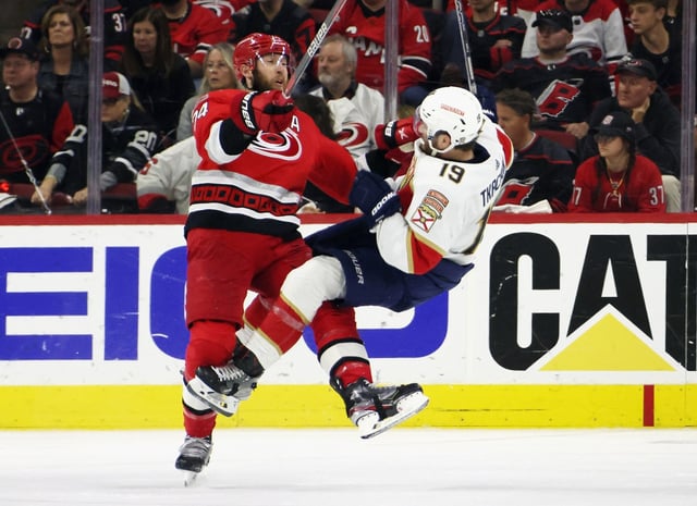 RALEIGH, NORTH CAROLINA - MAY 19: Jaccob Slavin #74 of the Carolina Hurricanes checks Matthew Tkachuk #19 of the Florida Panthers in Game One of the Eastern Conference Final of the 2023 Stanley Cup Playoffs at PNC Arena on May 19, 2023 in Raleigh, North Carolina. The Panthers defeated the Hurricanes 3-2 in the fourth overtime. (Photo by Bruce Bennett/Getty Images)