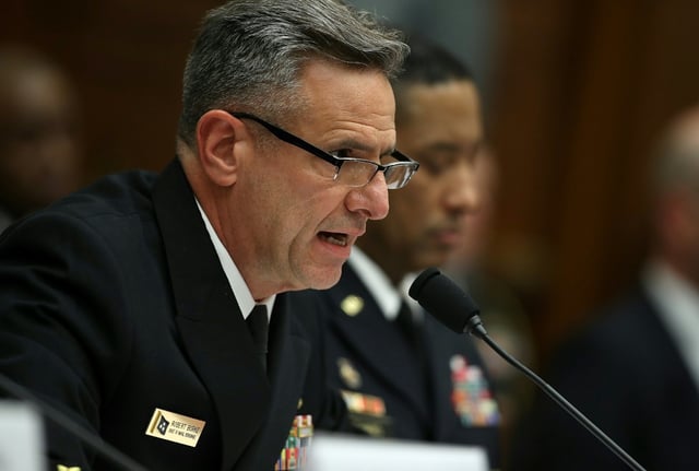 Retired US Navy Admiral Robert Burke is accused of steering contracts to a firm in return for a lucrative job after he retired
