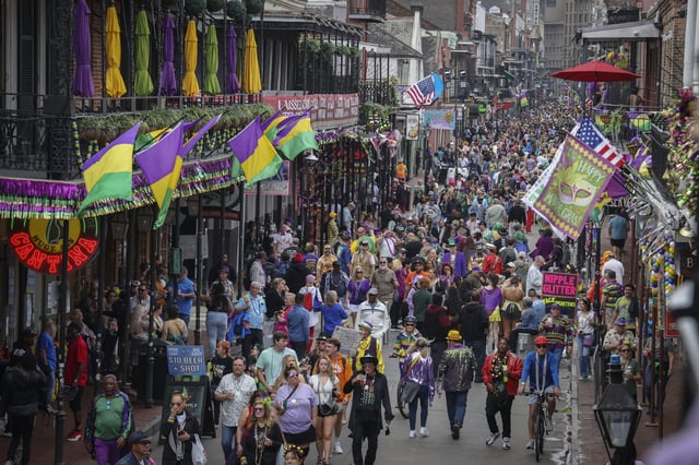 Revelers slong Bourbon Street on Mardi Gras day in New Orleans, Louisiana on March 4, 2025.