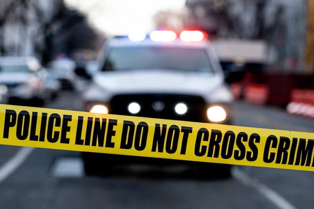 Police tape is seen in front of a police vehicle near the White House in Washington, DC, on February 14, 2022.