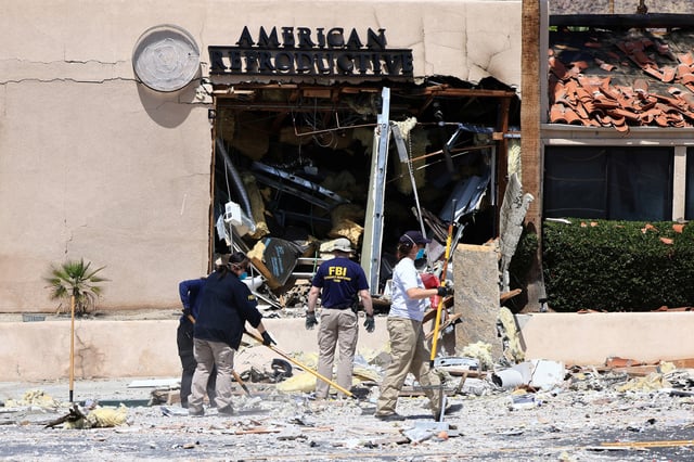 FBI and other law enforcement personnel gather evidence a day after a bomb exploded near a reproductive health facility in Palm Springs, Calif., May 18, 2025.