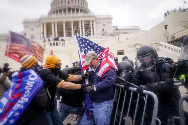 Rioters try to break through a police barrier outside the U.S. Capitol, on Jan. 6, 2021.