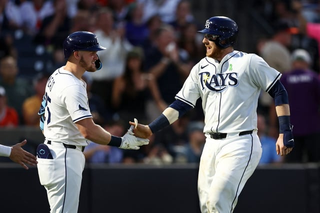TAMPA, FLORIDA - MAY 19: Danny Jansen #19 of the Tampa Bay Rays (R) celebrates with Curtis Mead #25 after hitting a two-run home run during the fifth inning of a game against the Houston Astros at George M. Steinbrenner Field on May 19, 2025 in Tampa, Florida. (Photo by Kevin Sabitus/Getty Images)