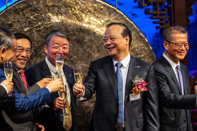 Robin Zeng, chairman of Contemporary Amperex Technology Co. (CATL), center, shares a toast with guests at the listing ceremony in Hong Kong, Tuesday, May. 20, 2025. (AP Photo/Chan Long Hei)