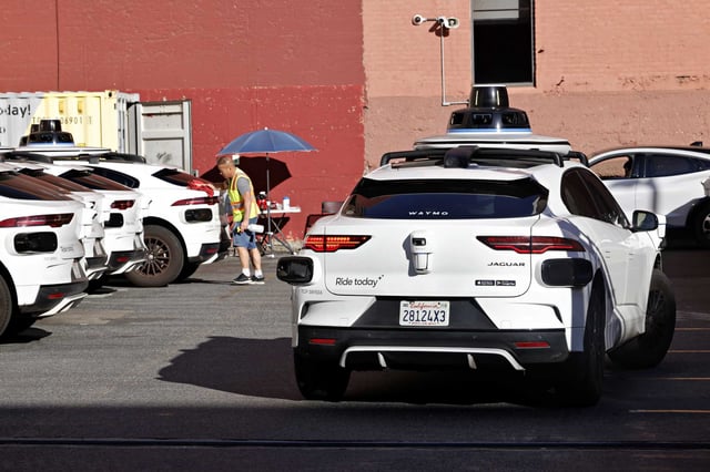 A person is seen working next to a Waymo car in a lot at 350 Pacific Avenue on Wednesday, January 15, 2025, in San Francisco. Waymo said Monday it received approval from the California Public Utilities Commission to expand to the South Bay and most of San Jose.