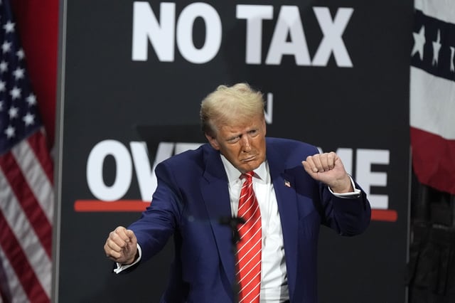 FILE - Republican presidential nominee former President Donald Trump dances at a campaign event at the Cobb Energy Performing Arts Centre, Oct. 15, 2024, in Atlanta. (AP Photo/John Bazemore, File)