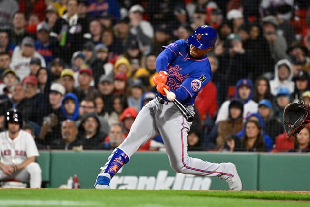 May 19, 2025; Boston, Massachusetts, USA; New York Mets right fielder Juan Soto (22) hits a single against the Boston Red Sox  during the sixth inning at Fenway Park. Mandatory Credit: Eric Canha-Imagn Images