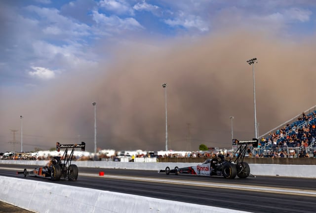 NHRA top fuel drivers Clay Millican, left, and Tony Stewart race as a dust storm approaches the track during qualifying for the Route 66 Nationals at Route 66 Raceway in Joliet on May 16, 2025. (Mark J. Rebilas/Imagn Images)