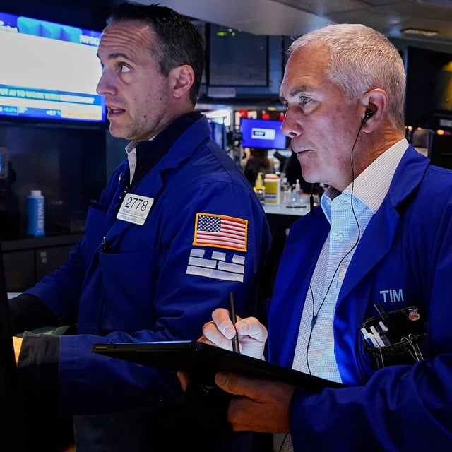 Specialist Michael Gagliano, left, and trader Timothy Nick work on the floor of the New York Stock Exchange, Wednesday, May 14, 2025. (AP Photo/Richard Drew)