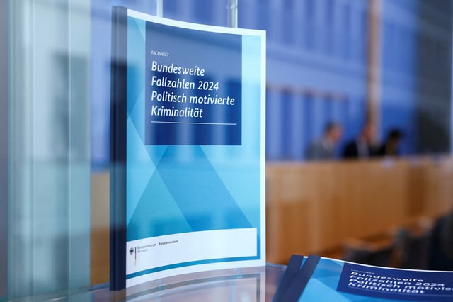 A report on Figures For Politically Motivated Crime in the Country is seen through glass, on the day of a press conference, in Berlin, Germany, May 20, 2025. REUTERS/Lisi Niesner
