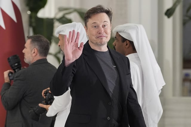 Elon Musk gestures as he arrives for a state dinner hosted by Qatar's Emir Sheikh Tamim bin Hamad Al Thani in honor of President Donald Trump at Lusail Palace in Doha, Qatar, Wednesday, May 14, 2025. (AP Photo/Alex Brandon)