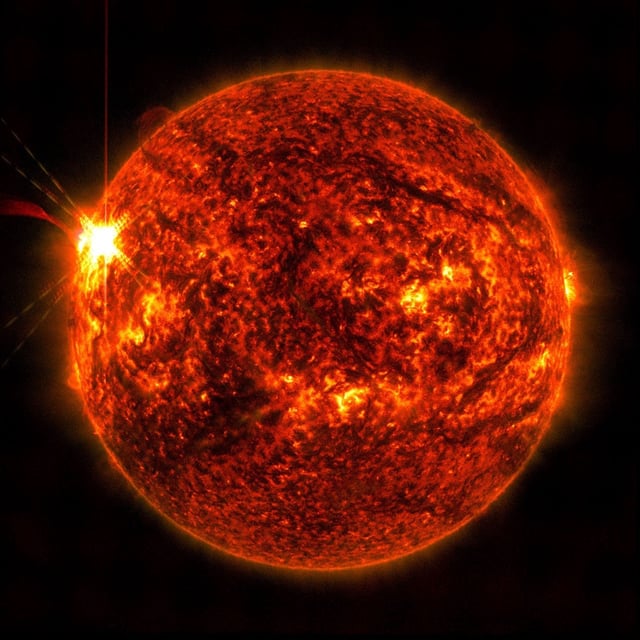 NASA’s Solar Dynamics Observatory captured this image of a solar flare — seen as the bright flash on the left – on May 14.
