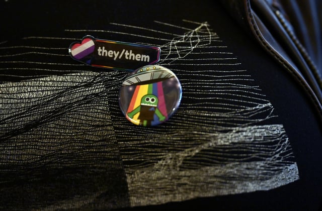Jamie Frederick wears pins during hearings on HB1312 in the Old Supreme Court hearing room at the Colorado State Capitol in Denver on April 30, 2025.   The Senate Judiciary Committee listened to testimony from opponents and proponents of  HB1312, which would extend legal protections to transgender people. Legislators took testimony for a total of 8 hours from both sides of the issue.  The bill is deeply contentious on two fronts: Republicans and &#34;parental-rights&#34; folks are opposed and some prominent LGBTQ+ groups have also expressed skepticism, belatedly, about some of its provisions because of legal fears. Over 400 hundred people testified for and against the bill. At the end of it  the bill&#39;s backers introduced amendments stripping out provisions of the bill. (Photo by Helen H. Richardson/The Denver Post)