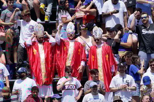 May 16, 2025; Chicago, Illinois, USA; Chicago White Sox fans dressed like Pope Leo XIV in the bleachers during a game between the Chicago Cubs and the Chicago White Sox at Wrigley Field.