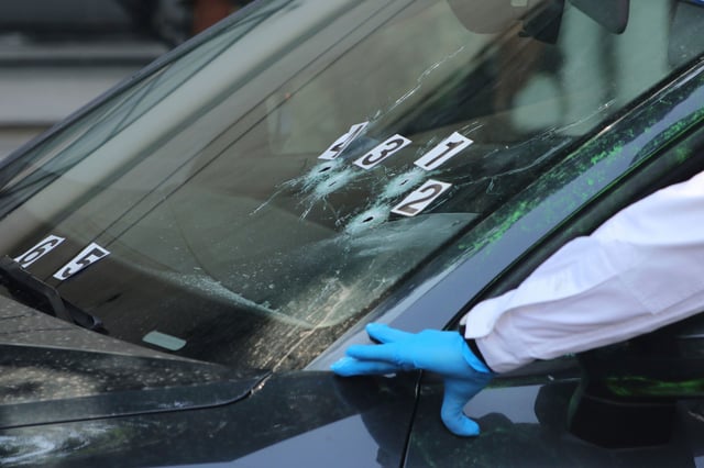 Crime scene investigators work at the site where the personal secretary and an adviser to Mexico City's mayor were killed by gunmen on a motorcycle, in Mexico City, Tuesday, May 20, 2025.