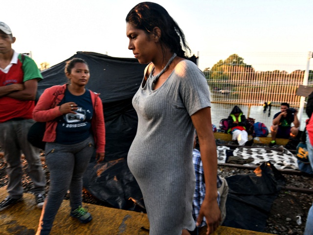 A Honduran pregnant woman taking part in a caravan heading to the US, waits to cross the border from Ciudad Tecun Uman in Guatemala, to Ciudad Hidalgo, Mexico, on October 22, 2018. - President Donald Trump on Monday called the migrant caravan heading toward the US-Mexico border a national emergency, saying he has alerted the US border patrol and military. (Photo by ORLANDO SIERRA / AFP) (Photo by ORLANDO SIERRA/AFP via Getty Images)