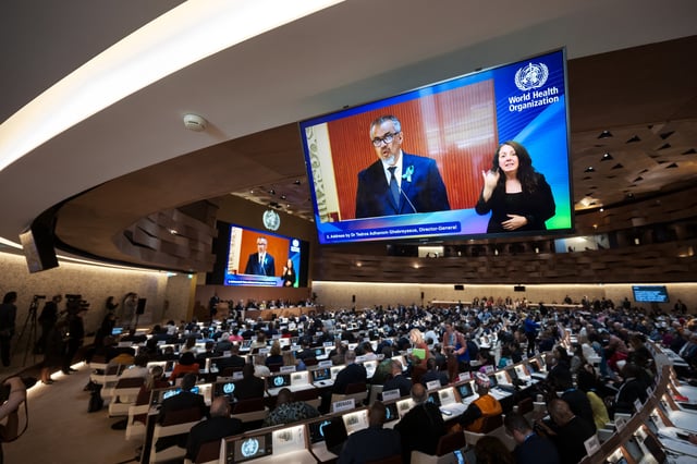 World Health Organization (WHO) Director-General Tedros Adhanom Ghebreyesus is seen on a screen delivering his report before delegates during the World Health Assembly in Geneva on May 19, 2025. (Photo by Fabrice COFFRINI / AFP) (Photo by FABRICE COFFRINI/AFP via Getty Images)