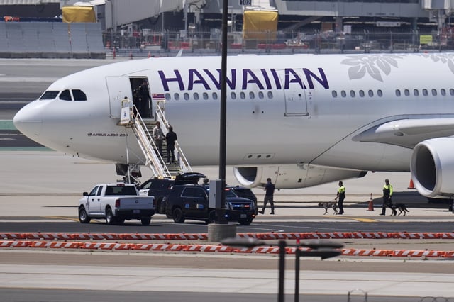 A Hawaiian Airlines airplane sits on the tarmac after an evacuation on Tuesday, May 20, 2025, at the San Diego International Airport in San Diego. (AP Photo/Gregory Bull)