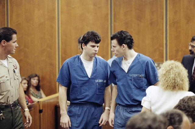 FILE – Lyle, left, and Erik Menendez leave a courtroom in Santa Monica, Calif., Aug. 6, 1990, after a judge ruled that conversations between the brothers and their psychologist after their parents were slain were not privileged and could be used as evidence. (AP Photo/Nick Ut, File)