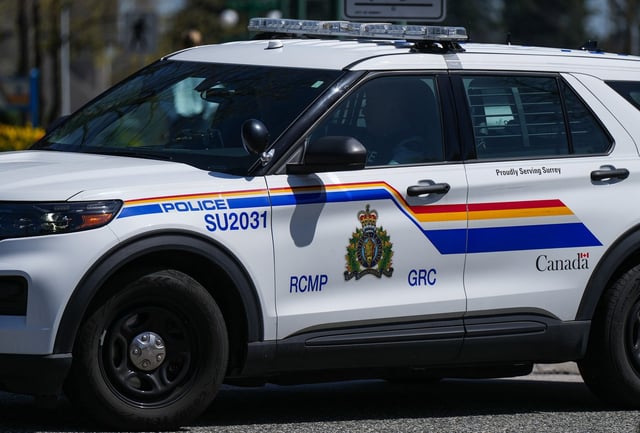 An RCMP officer drives a police vehicle in Surrey, B.C., on Friday, April 28, 2023. THE CANADIAN PRESS/Darryl Dyck