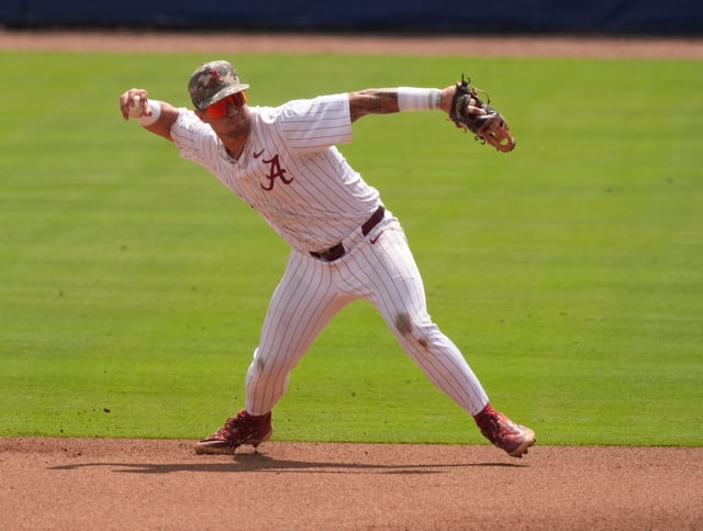 May 20, 2025; Hoover, AL, USA; Alabama second baseman Brennen Norton (21) fields a grounder and throws to first during the game with Missouri in the first game of the SEC Baseball Tournament at the Hoover Met.