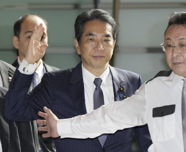 Japan's Agriculture Minister Taku Eto, center, arrives at the prime minister's office in Tokyo Wednesday, May 21, 2025. (Kyodo News via AP)