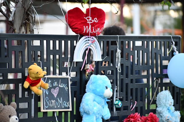Tributes are left for two young boys as mourners pay respects to two young boys following their deaths during a vigil in Coonabarabran, New South Wales, Friday, May 9, 2025. Mourners are remembering the lives of two young boys found dead in a small rural community as their maternal grandmother awaits serious charges. (AAP Image/Kait Britton) NO ARCHIVING