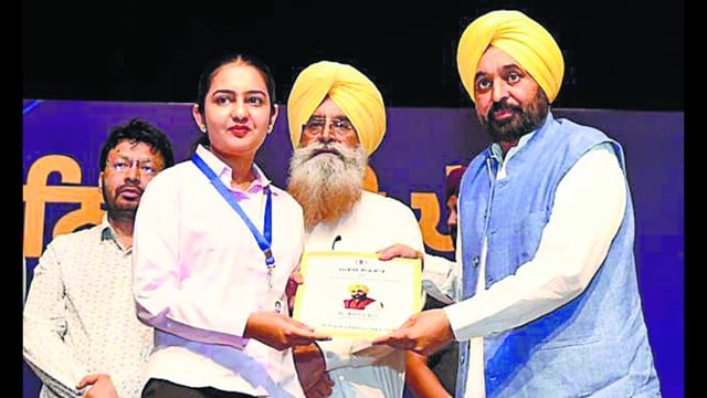 A recruit receives a job letter in Chandigarh on Tuesday. (HT)