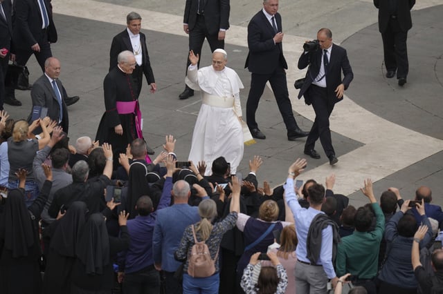 Pope Leo XIV waves at the end of his first weekly general audience in St. Peter's Square at The Vatican, Wednesday, May 21, 2025. (AP Photo/Alessandra Tarantino)