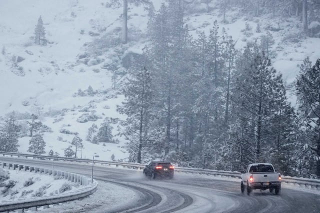 Vehicles travel along Highway 50 during a snow storm near Echo Lake (El Dorado County) on Feb. 13.