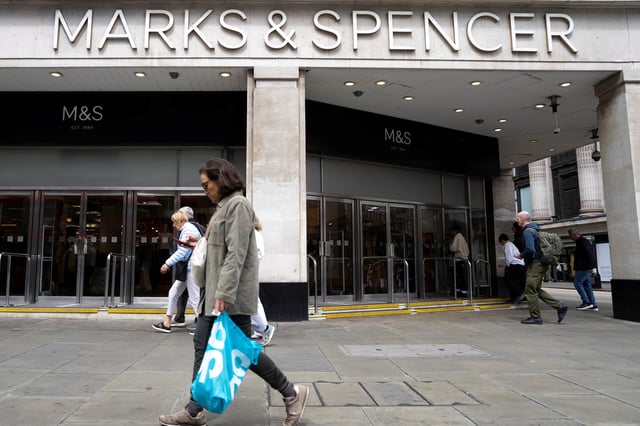 Pedestrians walk past the Marble Arch branch of British retailer Marks & Spencer Plc in central London, Britain, May 18, 2025. REUTERS/Carlos Jasso/File Photo