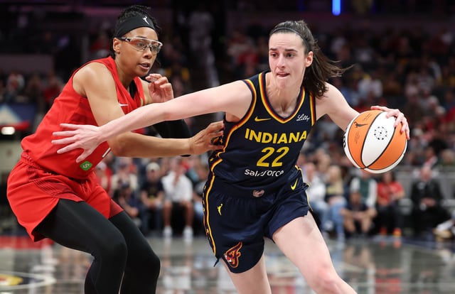 Caitlin Clark #22 of the Indiana Fever dribbles the ball while defended by Allisha Gray #15 of the Atlanta Dream at Gainbridge Fieldhouse on May 20, 2025 in Indianapolis, Indiana.